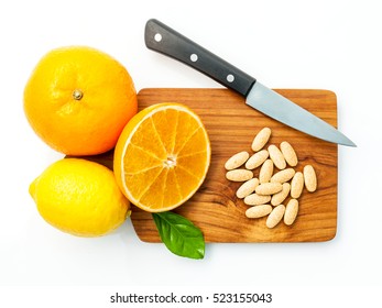 Vitamin C Tablets And Citrus Fruits On Wooden Cutting Board.Top View Shot Of Orange And Lemon Become Vitamin C, In Concept Of Extract Vitamin C From Citrus Fruits.Supplementary Health Food Nutrition.