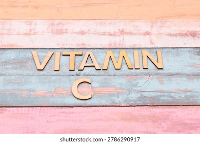 vitamin c write on rustical wooden background 