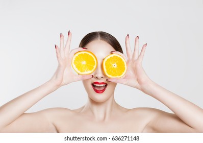 Vitamin C. A Young Woman Holding Two Half Oranges Isolated White Background