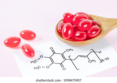 Vitamin Coenzyme Q10 With Chemical Formula On A Pink Background. To Prevent Aging. Pills And Medicine