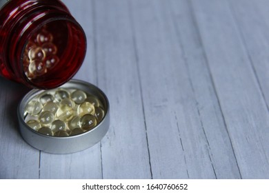 Vitamin D Pills, Red Container, Wooden Background