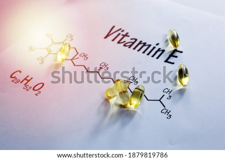 Vitamin E Or Alpha Tocopherols Softgels With Chemical Formula Written On White Background With Selective Focus.