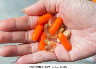 Vitamin E and Coenzyme Q10 in hand.
