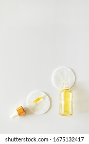Vitamin E In Glass Bottle And Pipette On Cotton Pads On White Background, Copy Space. Skincare Beauty Product, Above