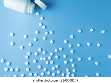 Vitamin Pills Flatlay On A Blue Background In A Plastic White Bottle. Vitamin Medical Prescription.