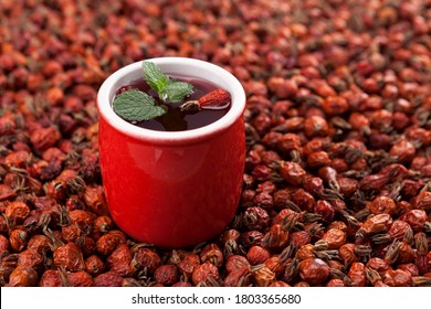 Vitamin tea or tincture from dried rosehip berries. Antioxidant, a tasty and healthy source of vitamin C. It is used in alternative medicine. Selective focus, horizontal orientation. - Shutterstock ID 1803365680