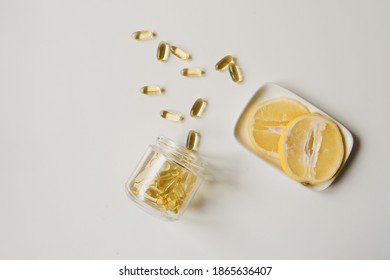 Vitamins In Bottle On White Background, Overhead View, Lemon Aside