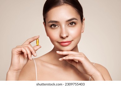 Vitamins. Close Up Of Happy Beautiful Girl With Pill With Cod Liver Oil Omega-3. Nutrition. Vitamin D, E, A Fish Oil Capsules. Healthy Lifestyle. Sport, Diet Concept - Powered by Shutterstock