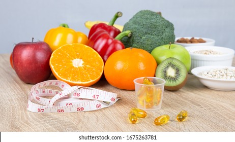 Vitamins, Measuring Tape, Grains, Fresh Vegetables And Fruits On Wooden Table. Healthcare, Healthy Diet, Nutrition And Weight Loss Concept.