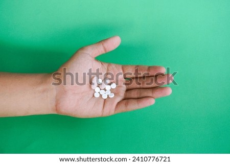 Vitamins, minerals and supplements pill capsules woman taking many pills top view of hand holding tablets.