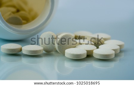 Vitamins, minerals and supplements tablets pills with open plastic bottle on white background. Zinc amino acid chelate dietary supplement product. Supplement boost male fertility and sperm count Stock photo © 