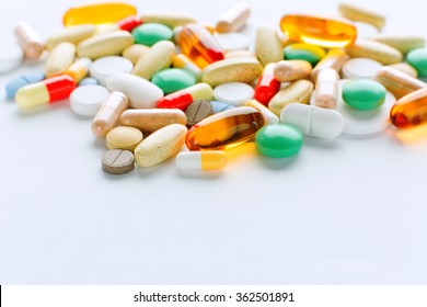 Vitamins, omega 3, cod-liver oil, dietary supplement and tablets an embankment on a light background close up, the top view