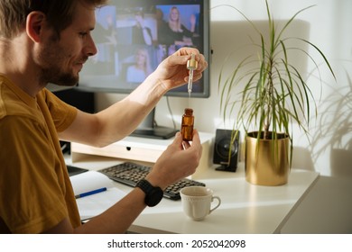 Vitamins and supplements. Hand holding pipette of Hemp oil. Close up man uses CBD oil. Medical cannabis. Healthy lifestyle. Man using cosmetic oil for skin care