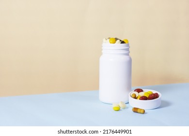 Vitamins And Supplements With A White Bottle On Vanilla And Blue Color Background. Including Multi Vitamins, Vitamin B, C, D, Collagen Tablets, Probiotics Capsules And Iron Capsules.