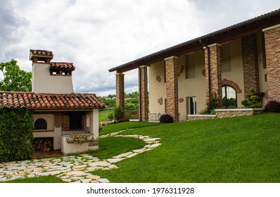 Vittorio Veneto, Italy - May 15, 2021: Detail Of The Courtyard Of An Ancient House On The Prosecco Hills. House With Brick Columns And An Outdoor Wood Stove.