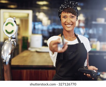 Vivacious Attractive Young African American Bar Tender Handing Back A Bank Card After Processing Payment Conceptual Of A Small Business Owner