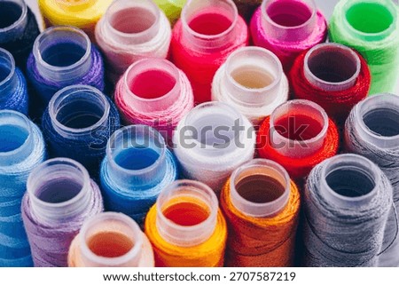 A Vivid Array of Colorful Thread Spools Perfect for Creative Projects and Crafting, Showcasing an Impressive Palette of Textiles and Artistry
