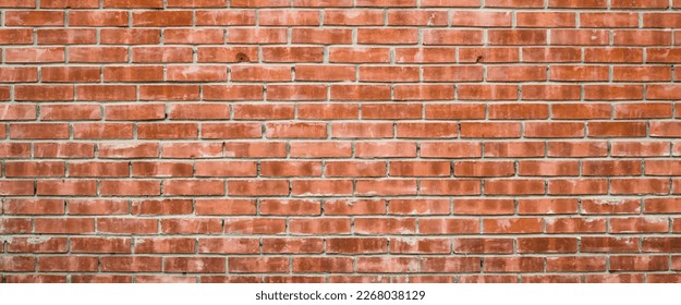 Vivid backdrop with old realistic red brick wall. Minimal fragment of orange brickwall close-up. Minimalist monochrome background with dirty wall of brown bricks close up. Simple wall texture.