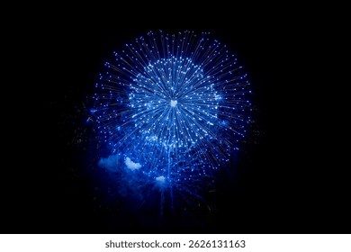 Vivid blue fireworks explosion lighting up the dark night sky, captured in high resolution. A symmetrical burst with sparkling trails, perfect for celebrations, festivals, and holiday