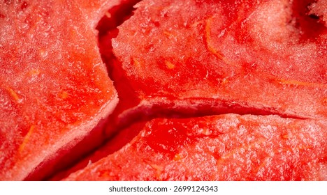 A vivid capture of a watermelon slice split deep along its core, revealing contrasting textures of moist red flesh and embedded seeds, embodying a luscious summer indulgence.