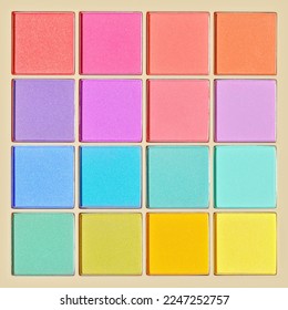 Vivid colored eye shadow makeup palette, pink, violet, blue, green colors. Female cosmetic and beauty product, shiny eye shadow in square package, aesthetic texture background, barbie style, top view