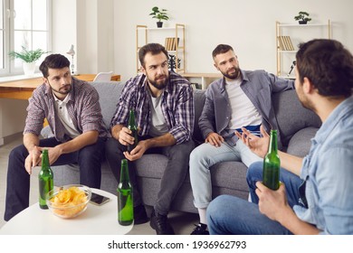 Vivid Discussion. Four Male Friends Are Drinking Beer And Having A Pleasant Conversation, Spending A Wonderful Time Together. Men Talk To Each Other Sitting At Home On The Couch.