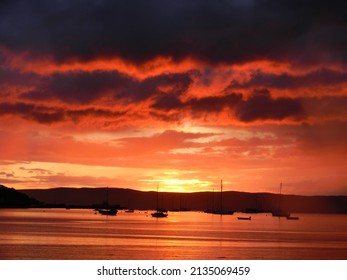 Vivid and dramatic orange sunset over the Mull of Kintyre 