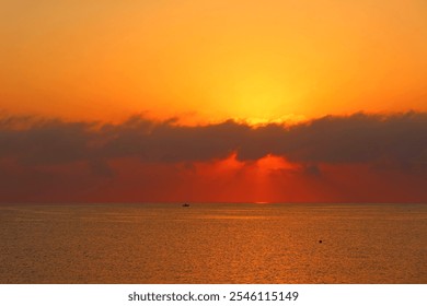 Vivid morning sun and small fisherman boat, calm sea. Dawn by the sea, landscape travel photography. Distant vivid sky and clouds, fishing boat, ocean and colorful sunrise. - Powered by Shutterstock