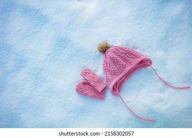 Vivid Pink Hat And Mittens In The Snow, Clean View From Above, Winter Holidays Concept