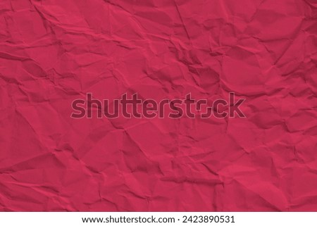 A vivid red crumpled paper texture that gives a sense of depth and dimensionality. Background for color and texture.