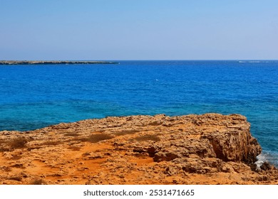 Vivid rocky coastline, blue calm sea and small fast boat, shore with the stones. Blue sky and sunny summer day, horizon and rock. Sea and ship Adventure trip, travel picture. - Powered by Shutterstock