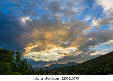 Vivid Sunset With Sunrays And Clouds