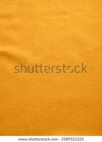 Vivid yellow background featuring a subtle fabric texture, perfect for creative designs or digital needs.