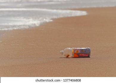 Vizag, AndhraPradesh/India - March 2019 : An Empty Plastic Soft Drink Bottle Laying In The Beach  - Ocean Plastic Concept