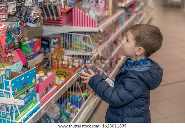Vladivostok / Russia - December 2019: Toddler boy\
select a toy in toy\
store.