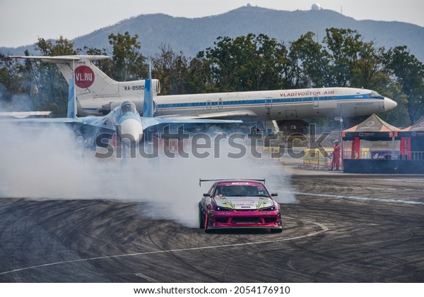 VLADIVOSTOK, RUSSIA - OCTOBER 02: Car\
drift, Sports car wheel drifts and a lot of smoke on the track.\
Russian drift show RDS without borders on October 02,\
2021.