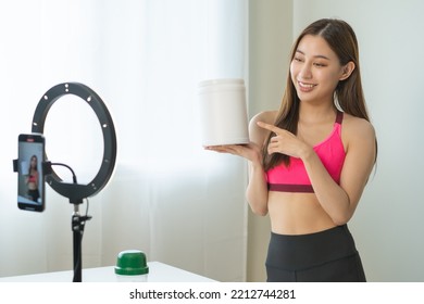 Vlogger Asian Young Woman Blogger, Influencer Showing Product Of Health Care, Using Smart Mobile Phone Live Selling Food Replacement, Weight Lose. Show Goods To Customer, Present, Streaming Online.