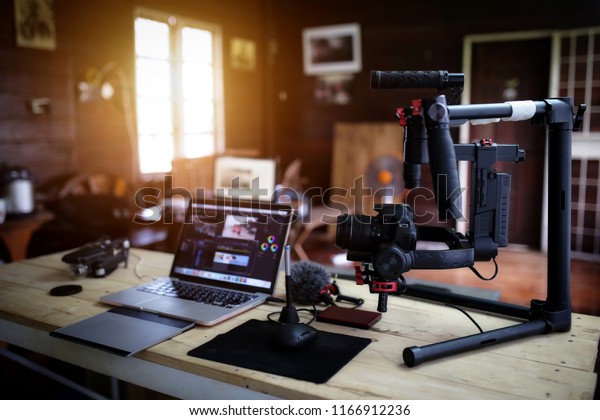 Vlogger equipment for\
Filming a movie or a video blog Drone Steadicam Camera Stabilizer\
and laptop.