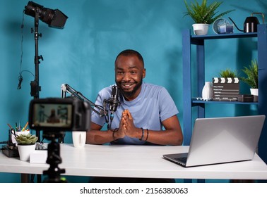 Vlogger saying thank you to audience in front of recording digital video camera at the end of online live show. Social media content creator doing closing line finishing video podcast. - Powered by Shutterstock