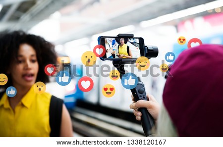 Vlogger streaming a live video live at a train platform