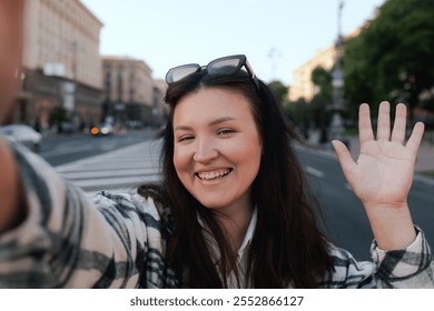 Vlogger traveler woman recording video on phone camera share via app her travel vacation in the city. Gen Z Plus size girl influencer shooting social media stories on the street. Part of a series. UGC - Powered by Shutterstock