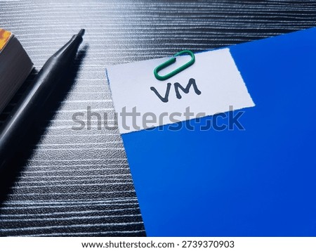 VM writting on table background. 