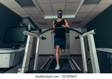 VO2 Max Test. Fit Young Man Running Fast On Treadmill With A Mask. Athlete Examining His Performance In Sports Science Lab.