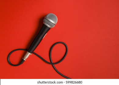 Vocal audio microphone on a bright red background