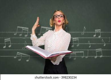 Vocal choir coach instructor nerdy singer singing in school classroom music teacher