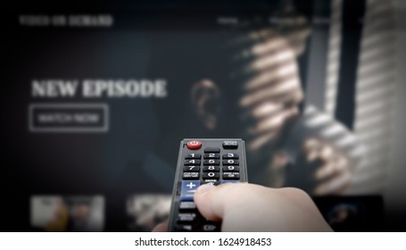 VOD Service On Television. Man Watching TV, Streaming Service, Video On Demand, Remote Control In Hand.