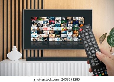 VOD service screen. Man watching TV with remote control in hand.