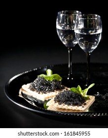 Vodka And Black Caviar On Black Background