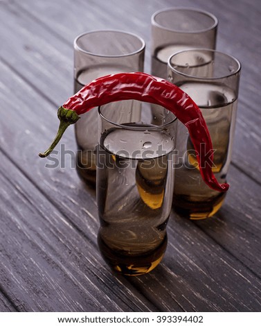 Vodka and chilli pepper. Selective focus