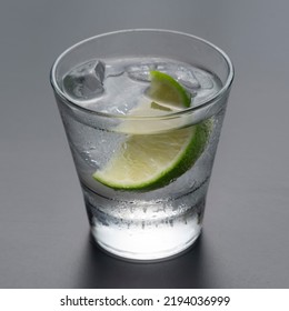 Vodka Or Gin With Lemon In Rocks Glass On Grey Background